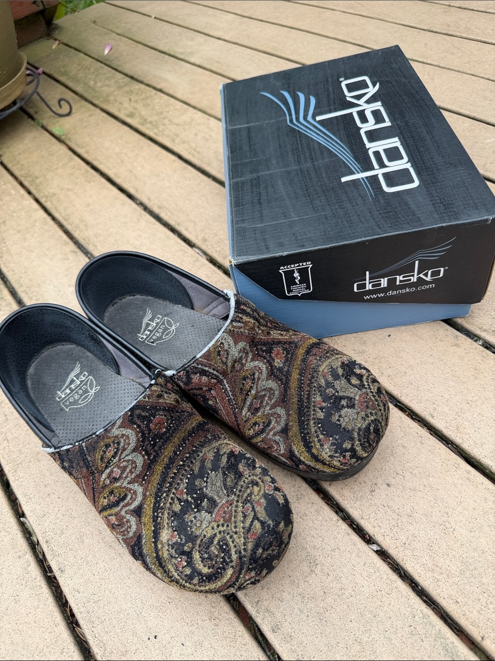 Dansko women’s Paisley Slip-On Clogs in Black and Brown